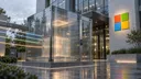 A transparent, access-controlled execution enclosure stands at the entrance of a Microsoft-branded technology building.