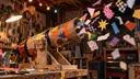 A homemade paper cannon sends colorful scraps flying in a workshop, evoking thoughtcrime’s Sloptoberfest slopcannon submission.