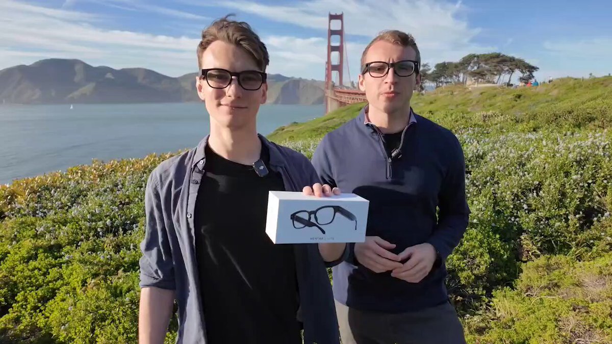 Mentra Live founders holding a box in front of the Golden Gate Bridge